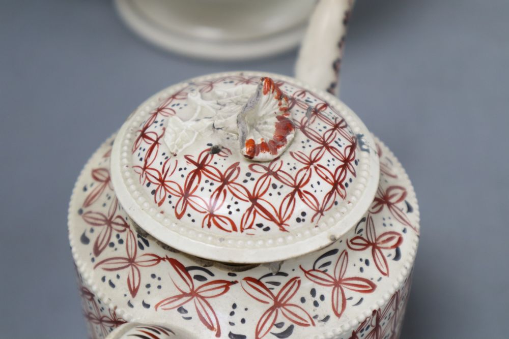 A late 18th century Leeds type creamware coffee pot and cover, an enamelled teapot and cover and a pearlware harvest jug, tallest 28c